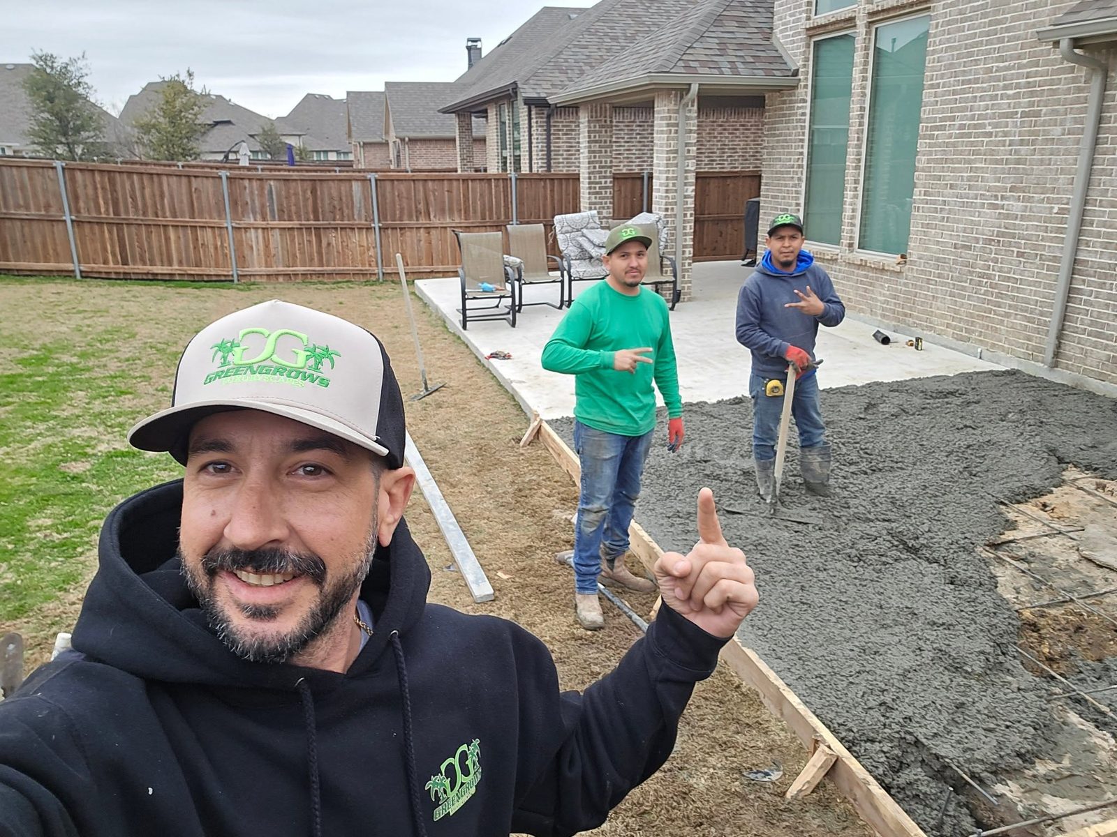 Mike Pfleger and the GreenGrows crew placing a concrete slab in DFW