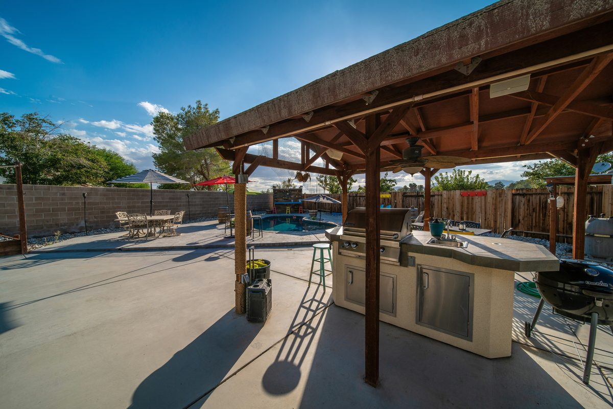 Poolside outdoor kitchen and bar with built-in grill